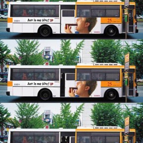bus with a guy eating choc bar ad